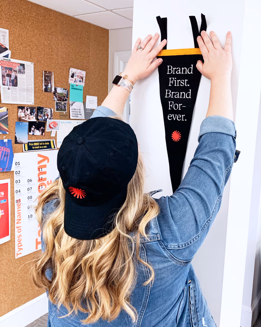 A woman hanging a paper to the wall