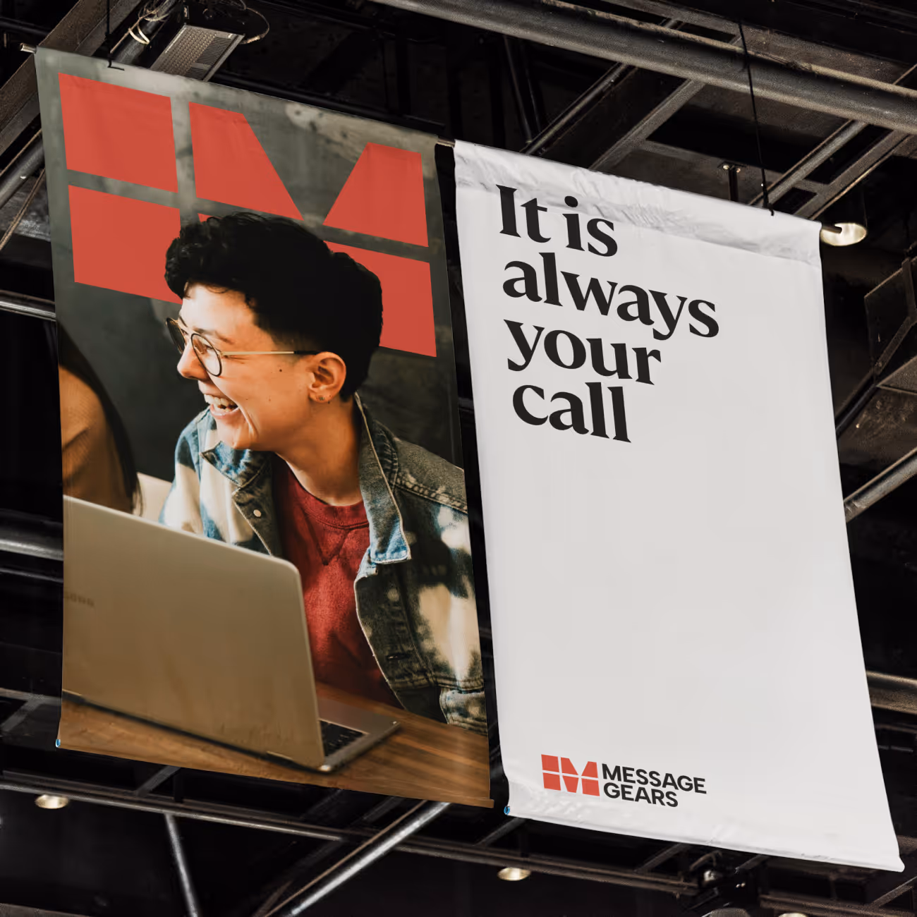 Two hanging banners, one with a smiling person using a laptop, the other reading 'It is always your call' with the Message Gears logo.